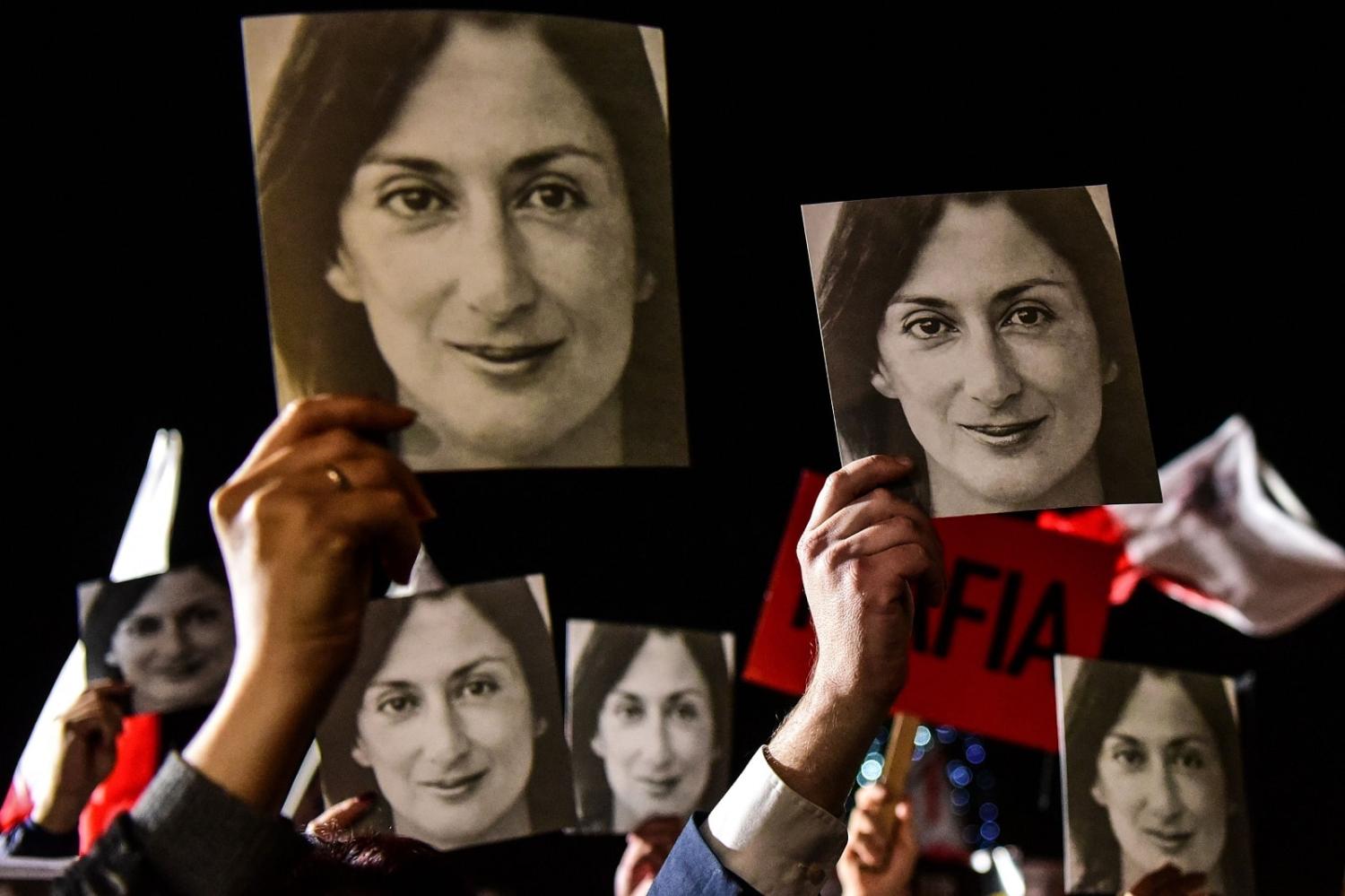 People gather outside the office of Malta's prime minister in Valletta in November 2019 to protest the death of journalist Daphne Caruana Galizia (Matthew Mirabelli/AFP via Getty Images)